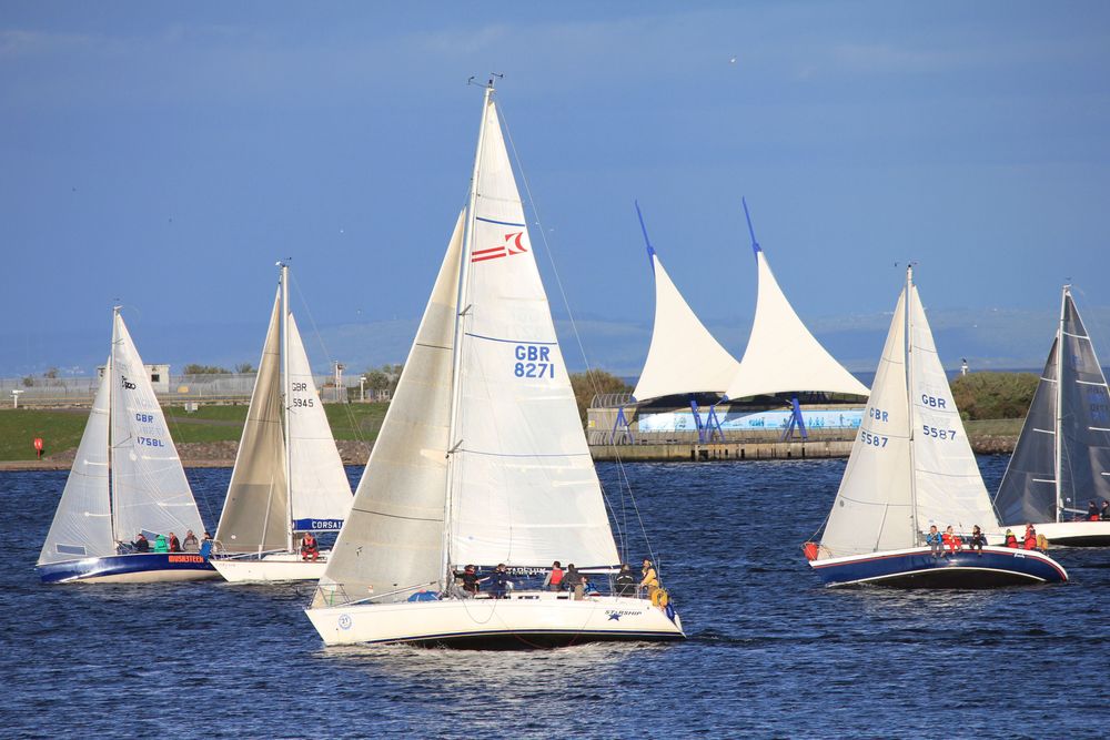 Boote in der Bucht mit den falschen Segeln im Hintergrund.